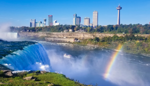 Blick von den Niagarafällen auf die Rainbow Bridge zwischen Kanada und den USA mit Regenbogen im Sprühnebel