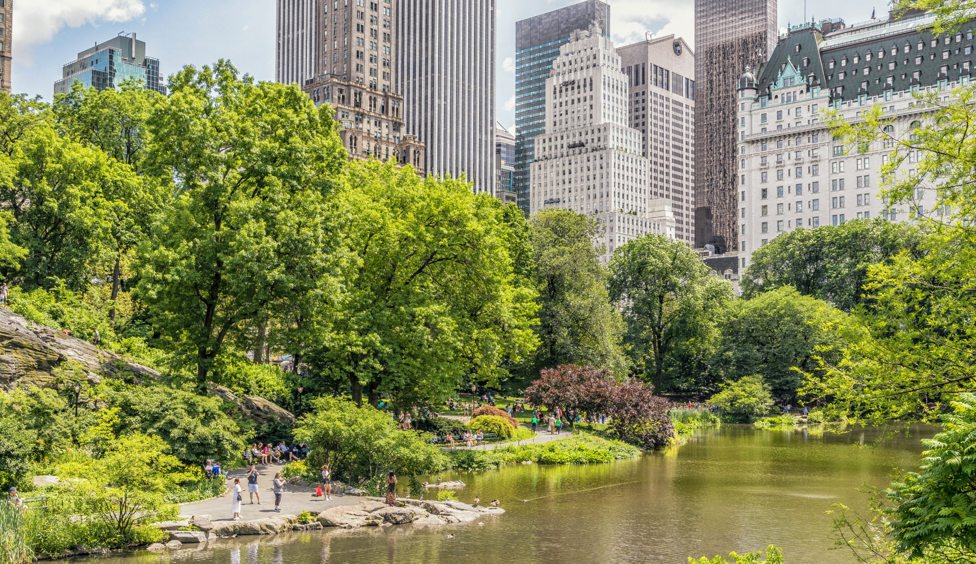 Central Park in New York mit See, Bäumen und Hochhäusern im Hintergrund