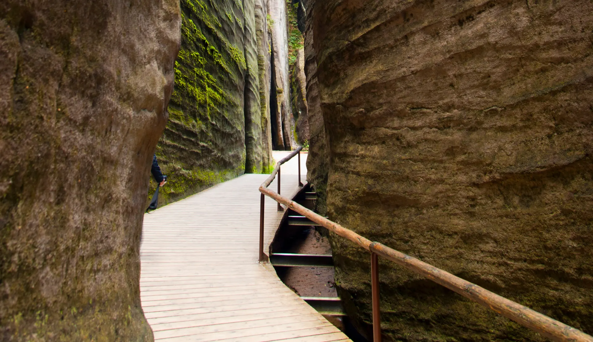 Enge Felsschlucht in der Adersbacher Felsenstadt mit Holzsteg, Treppe und moosbewachsenen Sandsteinwänden