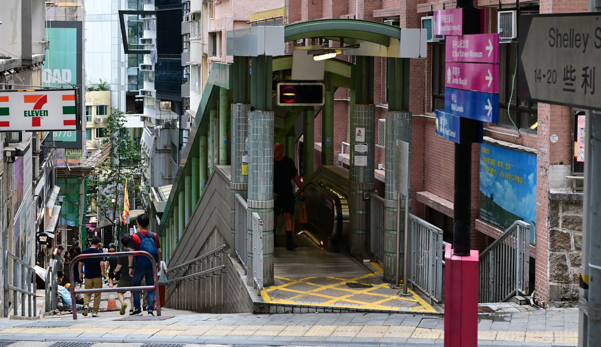 Mid-Levels Escalator in Hongkong Central mit charakteristischen Neonreklamen und typischer vertikaler Stadtarchitektur
