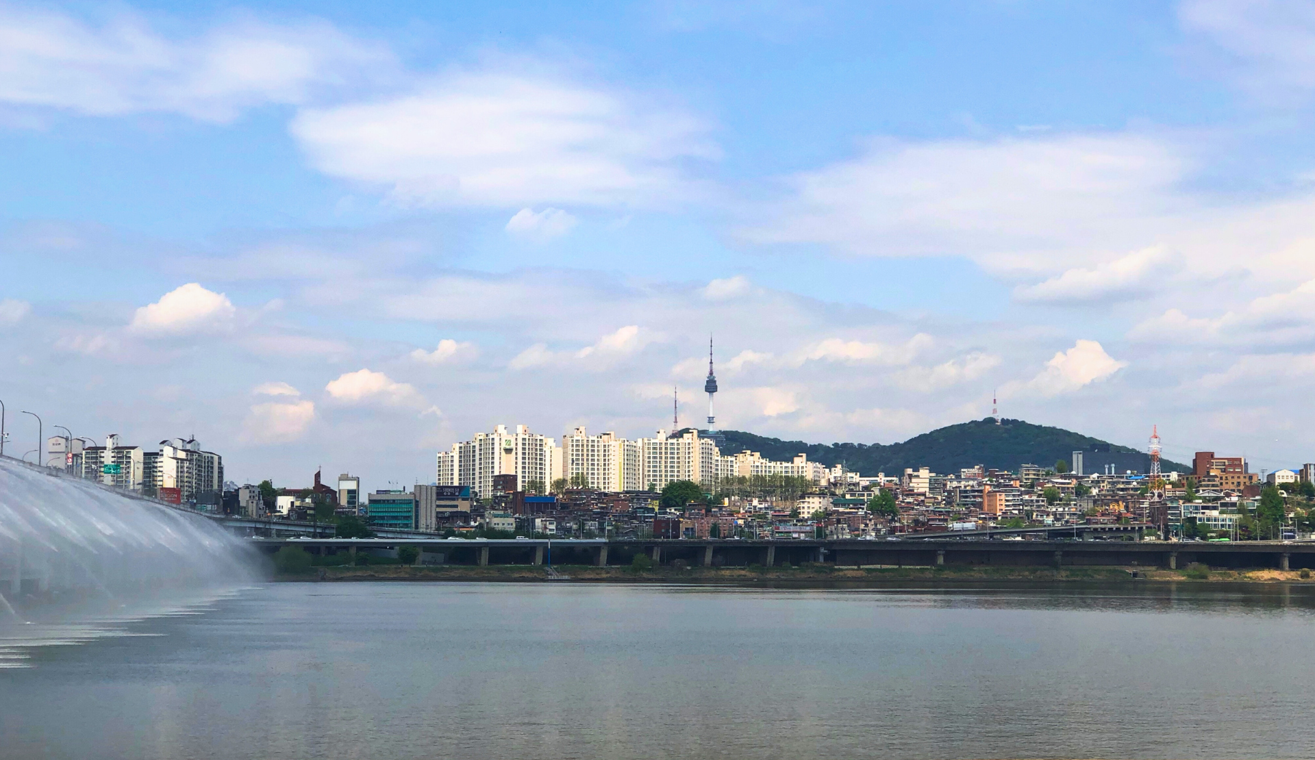 Blick auf die Skyline von Seoul mit dem N Seoul Tower und den Regenbogenfontänen der Banpo-Brücke am Han-Fluss